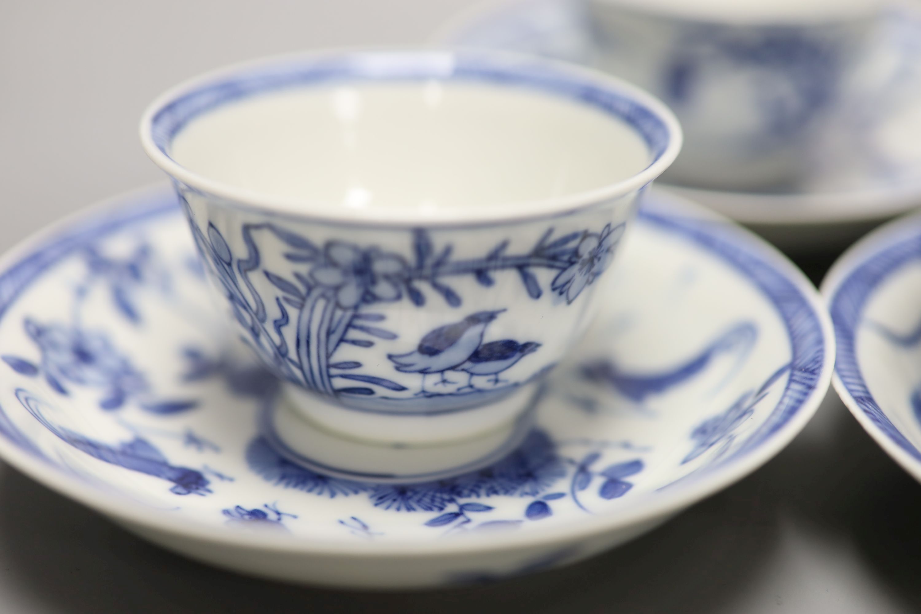 Five Chinese blue and white 'birds' tea bowls and four saucers and three 'chicken' tea bowls and four saucers (16)